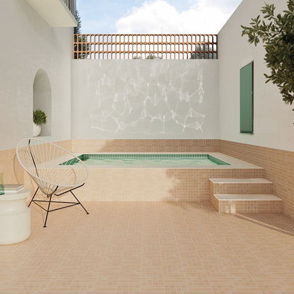Innenhof mit WOW Raster Fliesen in Clay, Kombination aus Grid S und Lines M als Boden- und Wandbelag rund um ein eingelassenes Becken, matte Keramikfliesen in handgemachter Optik mit warmer, geometrischer Raumwirkung.